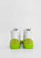 A pair of MH0100 White Leather / Lime high-top sneakers with green soles and heel patches, handcrafted in Portugal using premium Italian leathers, viewed from the back against a plain white background.