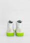 A pair of MH0097 White Leather W/ Lime with bright green soles and beige heel accents, handcrafted in Portugal, viewed from the back.