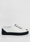 A pair of ML0066 White W/ Black sneakers with black soles and heel caps, handcrafted in Portugal from Premium Italian leathers, shown in a side view against a plain white background.