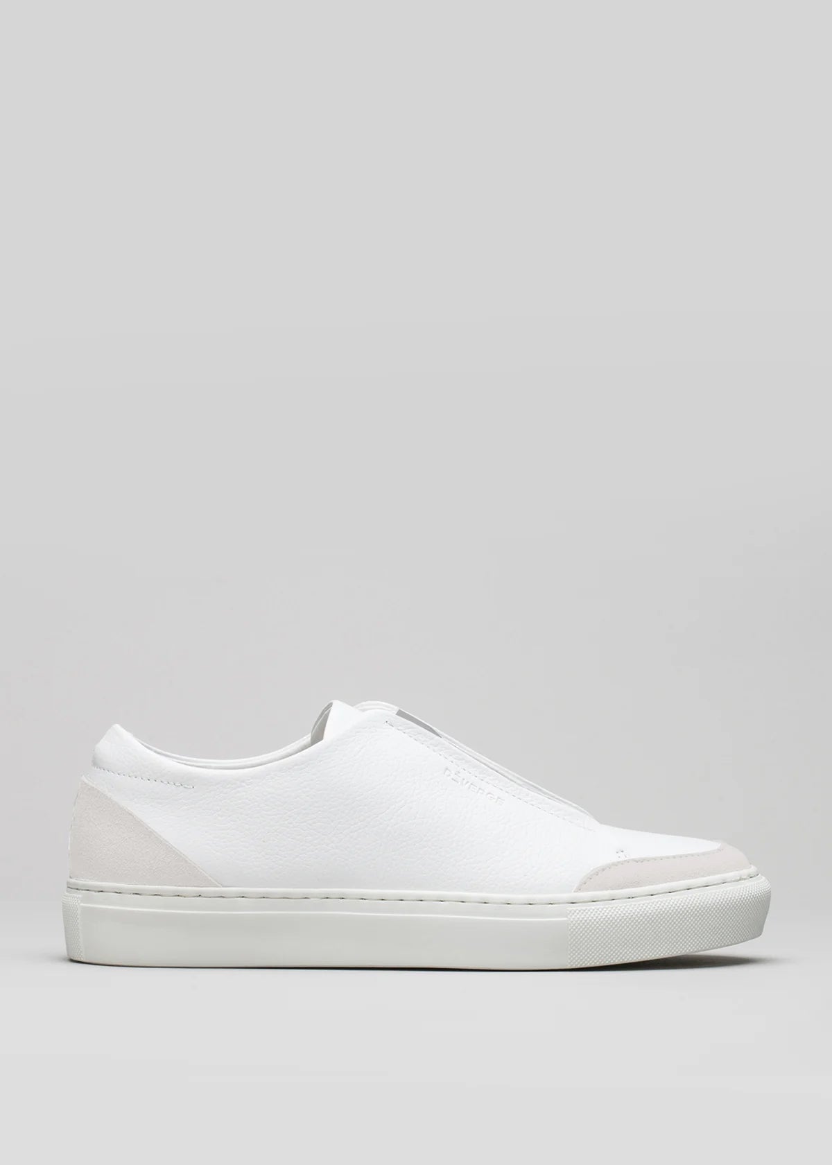 The V20 White W/ Bone slip-on sneaker is handcrafted with premium Italian leather, showcasing a smooth surface, minimalist design, and a low-profile rubber sole against a simple background.