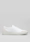 The V20 White W/ Bone slip-on sneaker is handcrafted with premium Italian leather, showcasing a smooth surface, minimalist design, and a low-profile rubber sole against a simple background.