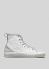 The TH0025 by Nicole is a white high-top sneaker, handcrafted in Portugal. It features light green accents, silver eyelets, and a white rubber sole set against a gray background.