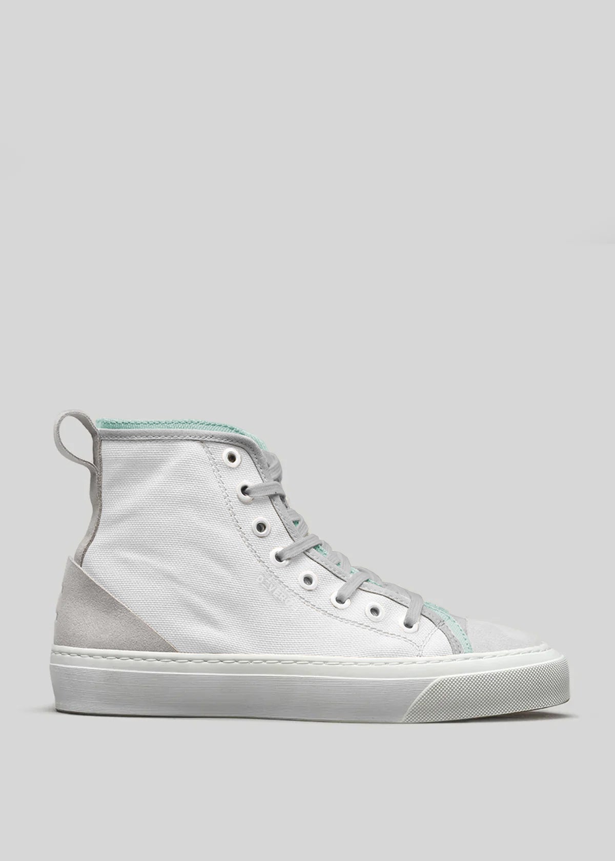 The TH0025 by Nicole is a white high-top sneaker, handcrafted in Portugal. It features light green accents, silver eyelets, and a white rubber sole set against a gray background.
