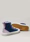 The TH0027 by Stella sneakers are showcased against a plain background. One shoe stands upright with a blue and lavender upper, while the other shows off its brown textured sole. Handcrafted in Portugal, these premium canvas high-tops blend style and quality craftsmanship.