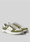 The V12 Olive W/ Off White sneakers are handcrafted, low-top shoes featuring green and white design, with white laces, displayed on a plain gray background.