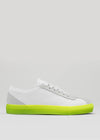 The V13 White W/ Yellow is a white low-top sneaker with light gray accents and a vibrant yellow sole, handcrafted in Portugal, displayed in side profile against a plain background.