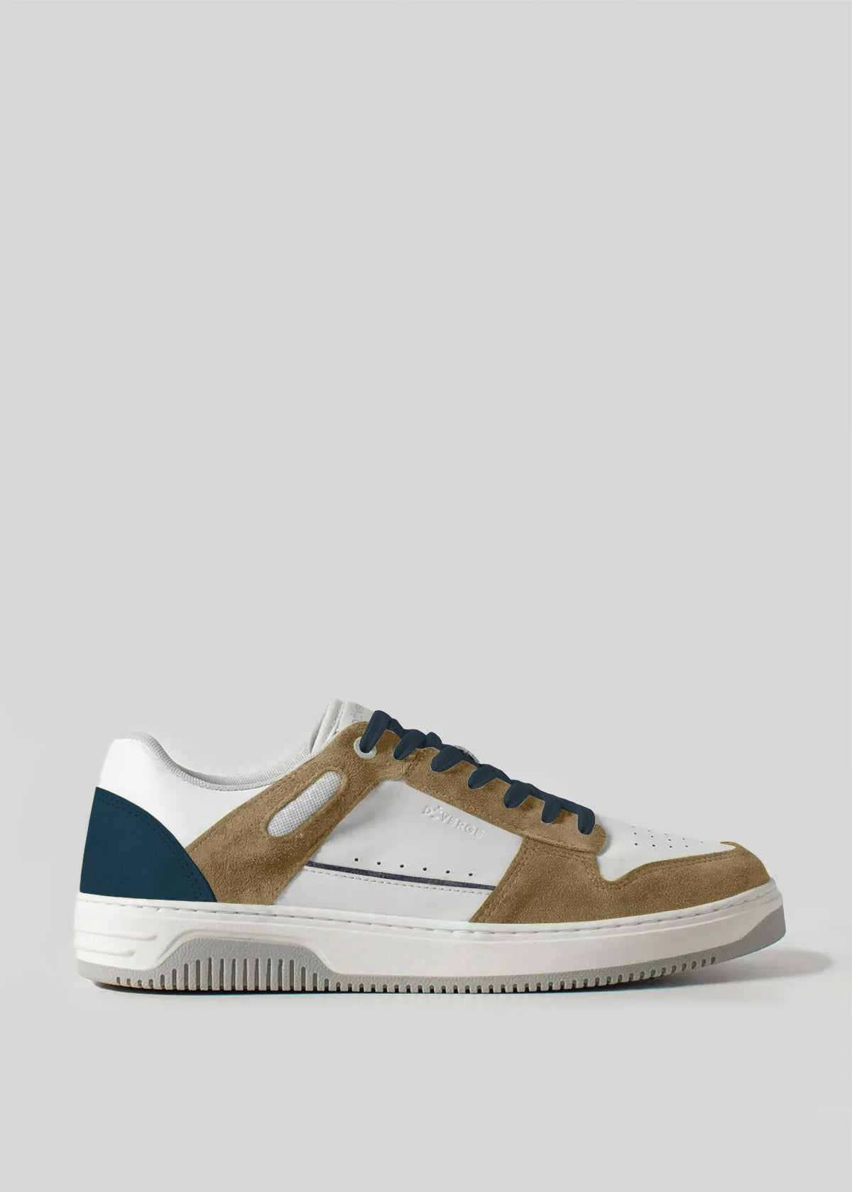 The V15 Beige W/ Ocean Blue sneaker features a white leather upper with premium Italian brown suede accents, a teal heel patch, and black laces, embodying retro-future design against a plain gray background.