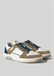The V15 Beige with Ocean Blue sneakers feature handcrafted white and tan uppers, navy laces, and rubber soles, set against a plain gray background.