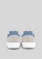Back view of V17 Lake Blue W/ Bone sneakers, light gray and blue with white soles, handcrafted in Portugal, against a plain gray background.