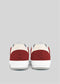 Back view of handcrafted V18 Off White W/ Scarlet sneakers on a gray background, highlighting their premium Italian leathers.