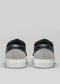 Back view of the V23 Deep Blue W/ Plaster sneakers in black and gray leather with white soles, expertly handcrafted in Portugal, displayed against a plain gray background.