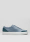 Side view of the V27 Lake W/ Petrol Blue low-top sneaker, crafted from premium Italian leathers with a smooth gray upper, teal accents on the toe and heel, and a white rubber sole against a plain background.