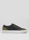 Side view of the V28 Black Leather W/ Olive sneaker, featuring a black and olive green design with a white sole, handcrafted in Portugal from premium Italian leathers, set against a plain gray background.