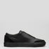 The V34 Black Leather is a slip-on sneaker featuring a smooth premium Italian leather upper, thick rubber sole, and subtle side branding, displayed on a plain gray background.