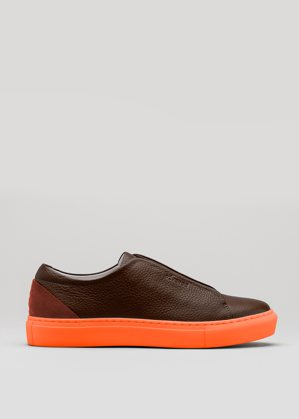 The V47 Brown W/ Orange sneakers boast a handcrafted design with premium Italian leathers and a striking bright orange sole, showcased in a side view against a plain background.
