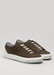 The V53 Brown W/ Bone sneakers, handcrafted in Portugal, showcase a minimalist design. Made from premium Italian leathers, they feature white soles and laces, with subtle heel accents. Displayed against a light gray background, these sneakers highlight their exquisite craftsmanship.