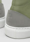 Close-up of the V53 Pine W/ Plaster sneaker, featuring a green and gray high top with a white sole, highlighting texture and stitching details on the heel. Handcrafted in Portugal with exquisite craftsmanship using premium Italian leathers.