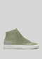 The V53 Pine W/ Plaster is a green high-top sneaker with a smooth finish and white sole, featuring light gray suede accents on the heel. Handcrafted in Portugal from premium Italian leathers, it offers both style and quality.