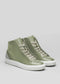 The V53 Pine w/ Plaster is a pair of green high-top sneakers, handcrafted in Portugal with premium Italian leathers, featuring white soles and laces against a plain gray background.