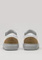 The V55 White Floater W/ Beige sneakers, handcrafted in Portugal, boast premium Italian leathers with brown heel accents and gray soles, shown from the back against a neutral background.