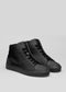 Un paio di scarpe MH0014 Pyck's Kicks in tela nera su sfondo grigio chiaro.
