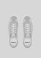 Top view of a pair of V4 Grey sneakers, meticulously handcrafted in Portugal from gray suede, featuring white laces and soles on a light gray background. The brand name is visible inside these low-top sneakers.