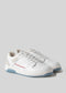 Une paire de baskets V6 Arctic Blue W/ White sneakers avec un détail de points rouges et des semelles bleues sur un fond gris clair.