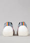 A pair of N0002 by Ricky with white soles, pale pink accents, and a colorful striped pattern at the back.