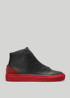 Side view of a custom black high-top MH0010 Bred sneaker with a contrasting thick red sole, set against a plain gray background.
