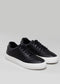 black synthetic leather sneakers in contemporary design frontview