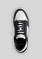 Top view of a V3 Black W/ White low top sneaker with laces on a gray background.