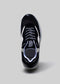 Top view of a L0002 by Mingo low top sneaker with thick laces and a loop on the heel against a gray background.
