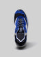 Vue de dessus d'une chaussure bleue et noire L0004 de Daniel avec des lacets blancs et une semelle grise sur un fond gris clair.