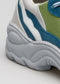 Close-up of a colorful V16 Leather Color Mix Pine shoe showing textured details of the white sole and blue and green fabric.