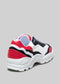 Una singola sneaker low top L0001 by Soraia caratterizzata da pannelli rossi, bianchi e neri con suola testurizzata bianca, su sfondo grigio.