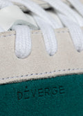 emerald green and bone premium leather sneakers in contemporary design close-up materials