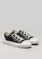 Une paire de chaussures en toile V2 Full Color Black présentée sur un fond gris clair.
