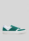 A side view of a V23 Green & White low top sneaker with a white sole and blue accents on the heel.