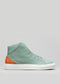 A V38 Green W/ White high-top sneaker with a burnt orange heel patch and a white sole, displayed against a plain gray background.