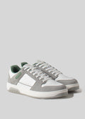 Une paire de V2 Grey W/ Forest Green sneakers sur un fond gris clair.