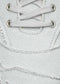 Close-up image of a V6 Full Color Light Grey showing laces and eyelets with detailed stitching and textured fabric.