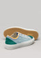 Une paire de chaussures basses TL0004 by Ana sneakers de couleur pastel avec un embout et des lacets blancs, présentées sur un fond neutre.