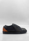 The ML0134 Deep Blue Floater W/ Caramel sneakers are crafted from premium Italian leathers, featuring a deep blue low-top design with a caramel heel accent on a plain white background. Handcrafted in Portugal for superior quality and style.