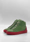 The MH0153 Aloe W/ Red sneakers feature handcrafted green premium Italian leather uppers and red rubber soles, displayed on a plain white background.