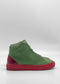 A single MH0153 Aloe W/ Red high-top sneaker boasts premium Italian green leathers with a red sole and heel, shown from the side on a plain white background.