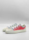 The TL0008 Geranium & Lilac sneakers are multi-colored, handcrafted in Portugal, with red, blue, and beige panels on a white background. Made from premium Italian leathers, they feature white laces and off-white soles.