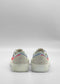 The TL0008 Geranium & Lilac are colorful sneakers with visible soles and heel sections, handcrafted in Portugal from premium Italian leathers, showcased against a plain gray backdrop.