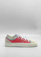 A side view of the TL0008 Geranium & Lilac sneaker shows its casually chic design with a white sole, red and light blue fabric, white laces, and metal eyelets. Ethically made to order from premium Italian leathers and expertly handcrafted in Portugal, it's set against a plain gray background.