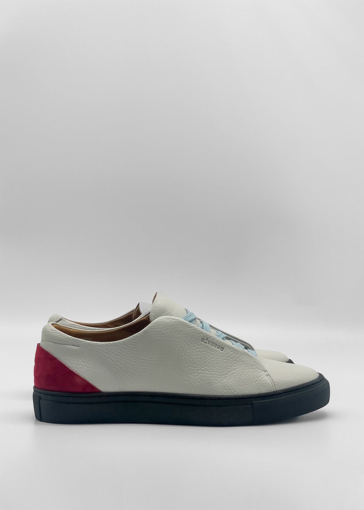 The ML0139 White W/ Red sneakers, handcrafted in Portugal, feature a red heel accent and blue soles. Made from premium Italian leathers, they are showcased in a side view against a plain white background.