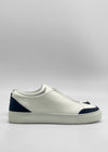 The SO0057 White Leather W/ Black sneaker is a handcrafted low-top shoe from Portugal, made with premium Italian leathers, featuring black accents on the heel and toe, and showcased on a plain white background.